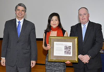 Dr. Helen Kim (center) was presented a 2012 Technical Excellence Award by MIT Lincoln Laboratory Director Eric Evans (left) and was introduced by Dr. Robert Atkins (right), head of the Advanced Technology Division.